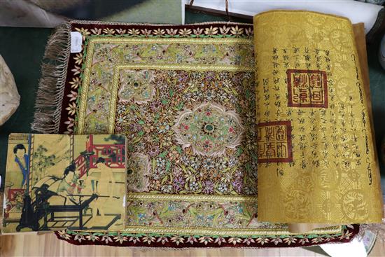 An Islamic scroll, a Chinese brocade panel, an embroidered and mounted panel and a book